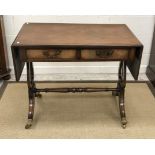 A 20th Century mahogany drop leaf sofa table in the George III taste on lyre end supports to