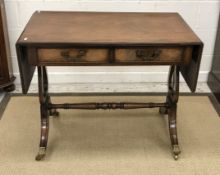 A 20th Century mahogany drop leaf sofa table in the George III taste on lyre end supports to