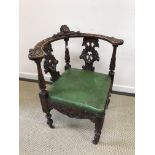 A 19th Century carved walnut corner chair with green upholstered seat,