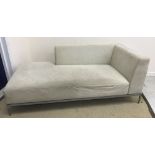 A Ligne Roset grey suede effect corner sofa on grey painted tubular framed base,