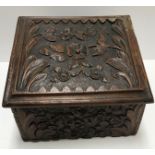 A 19th Century carved oak box with all over prunus blossom decoration,