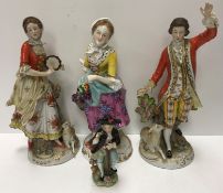 A pair of Sitzendorf porcelain figures in 18th Century dress each with a lamb at their feet,