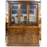 An Eastern hardwood dresser with three glazed sliding doors above two drawers and two pairs of