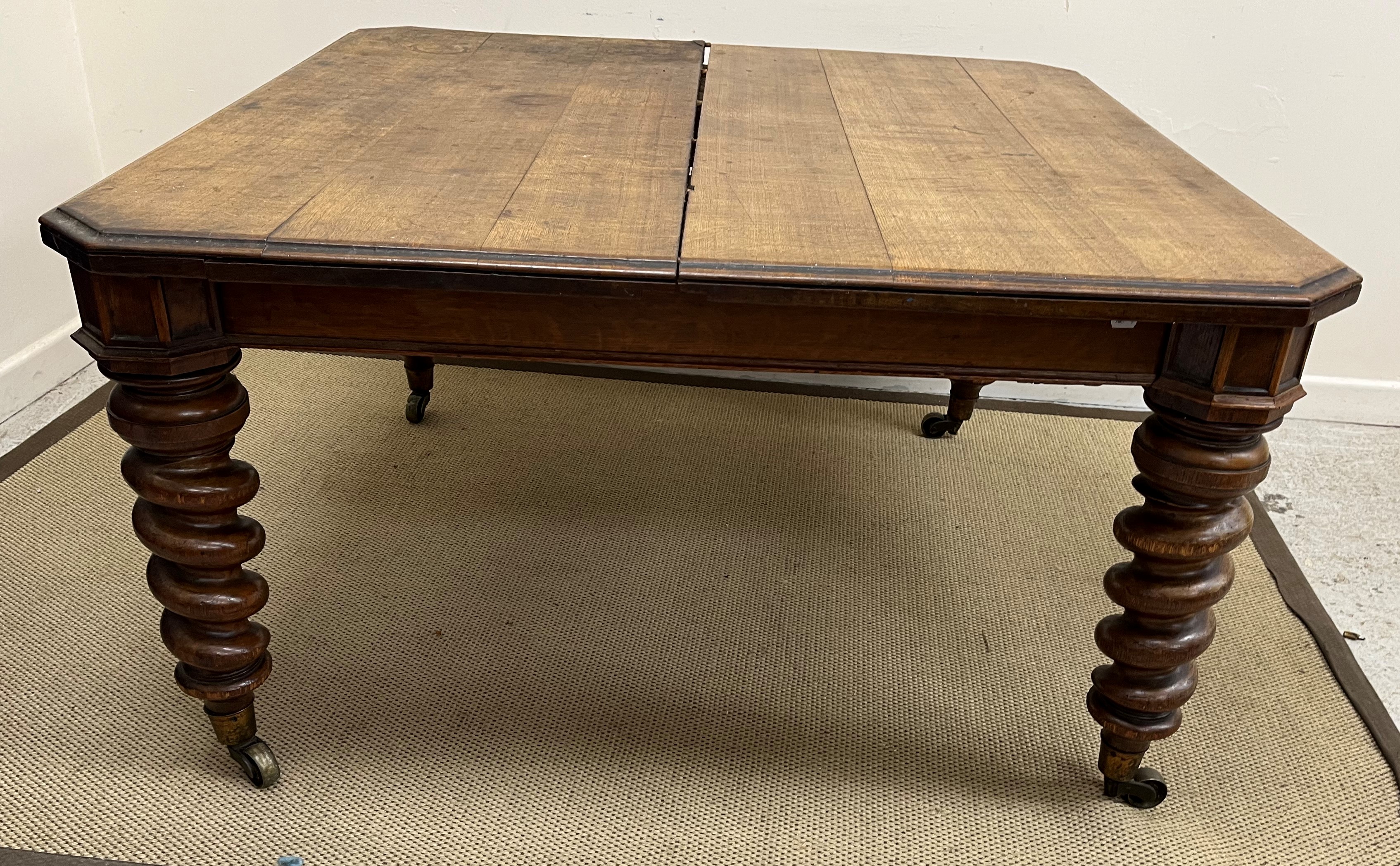 A Victorian oak extending dining table, - Image 2 of 5