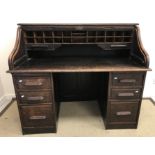 An early 20th Century oak tambour top desk,