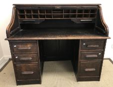 An early 20th Century oak tambour top desk,