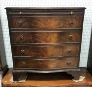 A 20th Century mahogany serpentine fronted bachelors chest in the George III taste,