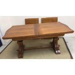 A modern walnut veneered extending dining table,