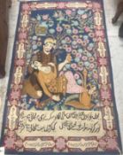 A Kashmir pictorial rug depicting a couple drinking beneath floral decorated trees on a blue ground