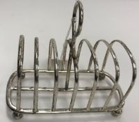 An Edwardian silver six section toast rack of plain form,