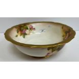 A Royal Worcester porcelain bowl with handpainted rose decoration and gilt highlighting,