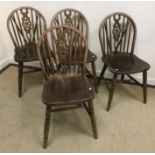 A set of four modern beech wheel and stick back kitchen chairs,