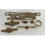 A collection of 9 carat gold comprising three Victorian and later bar brooches with red stone and