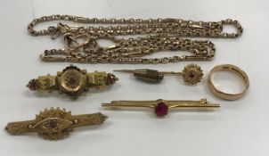 A collection of 9 carat gold comprising three Victorian and later bar brooches with red stone and