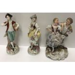 A Volkstedt figure of a couple in 18th Century dress dancing on a scrollwork decorated base,