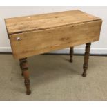 A pine drop leaf kitchen table on turned legs with single end drawer 90 cm x 90 cm wide x 75 cm