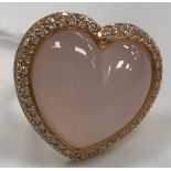 A modern 18 carat gold and rose quartz and diamond mounted ring of loveheart form,