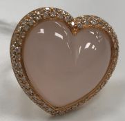 A modern 18 carat gold and rose quartz and diamond mounted ring of loveheart form,