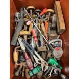 A crate of various hand tools and various fishing keep nets,