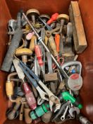 A crate of various hand tools and various fishing keep nets,