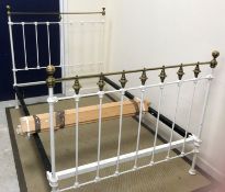 A late Victorian white painted iron and brass bedstead,