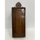 A 19th Century quarter cut oak candle box with sliding fielded panel and fretwork carved arched