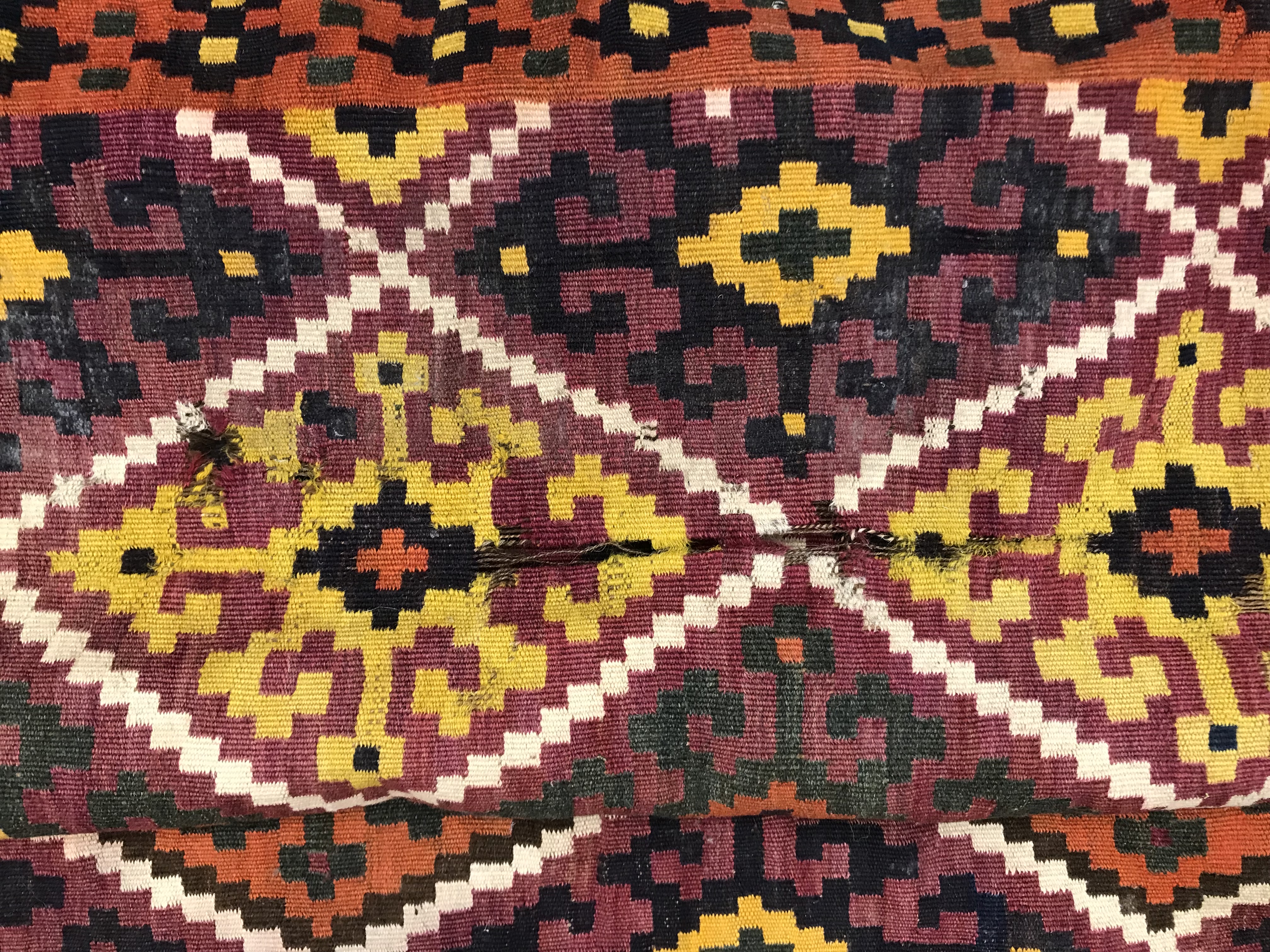 A Kelim rug, the central panel set with all-over lozenge decoration on a purple and orange ground, - Image 10 of 12