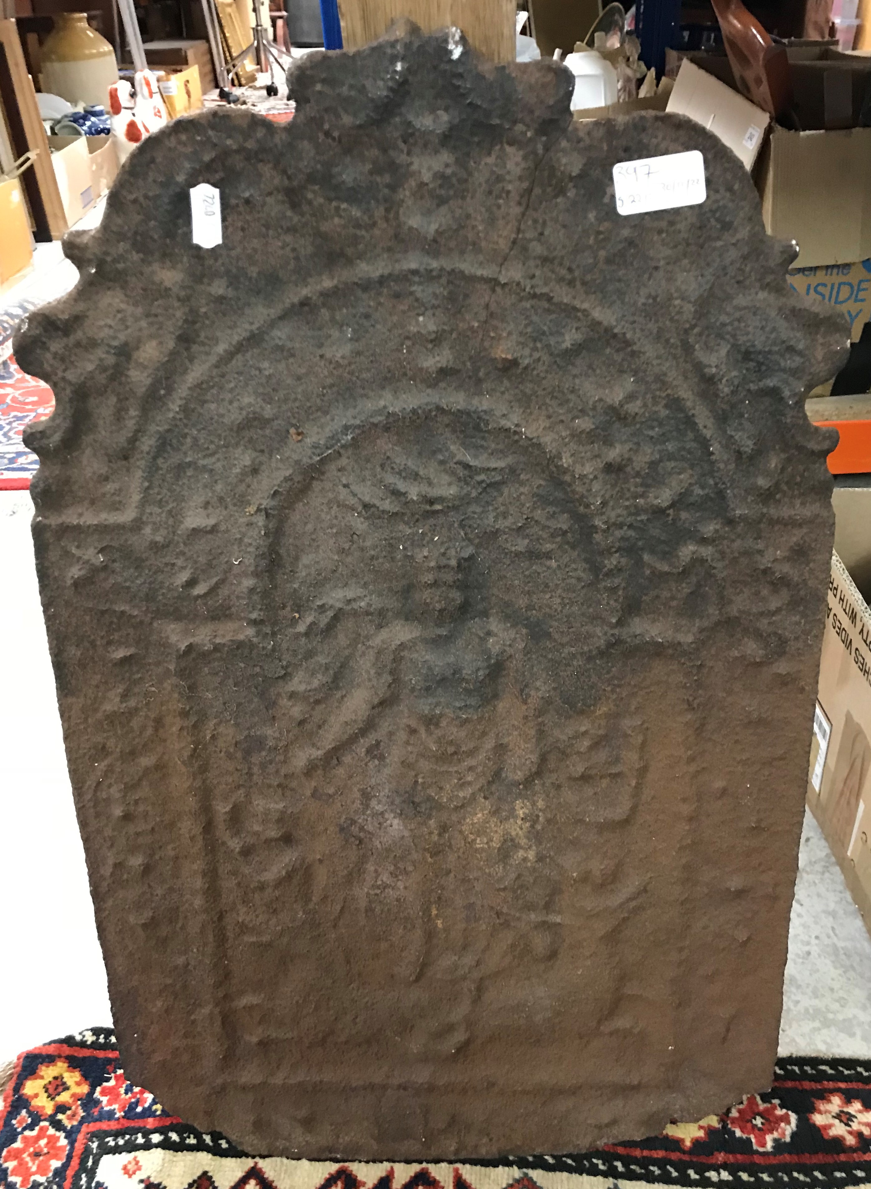 An 18th Century cast iron fire back with figural decoration 60cm high x 38cm wide and a pair of