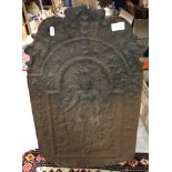 An 18th Century cast iron fire back with figural decoration 60cm high x 38cm wide and a pair of