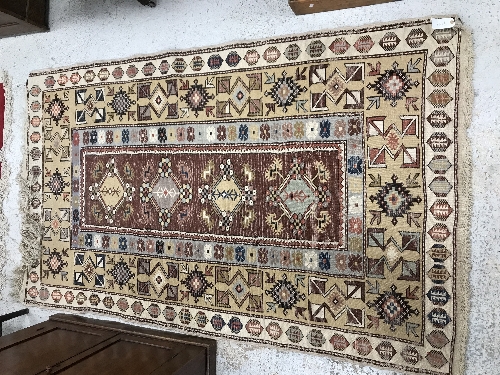 A Caucasian rug, the central panel set with five repeating medallions on a salmon pink ground, - Image 8 of 13