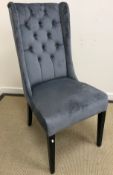 A modern faux blue grey suede buttoned shallow wing back chair on square tapered ebonised supports,