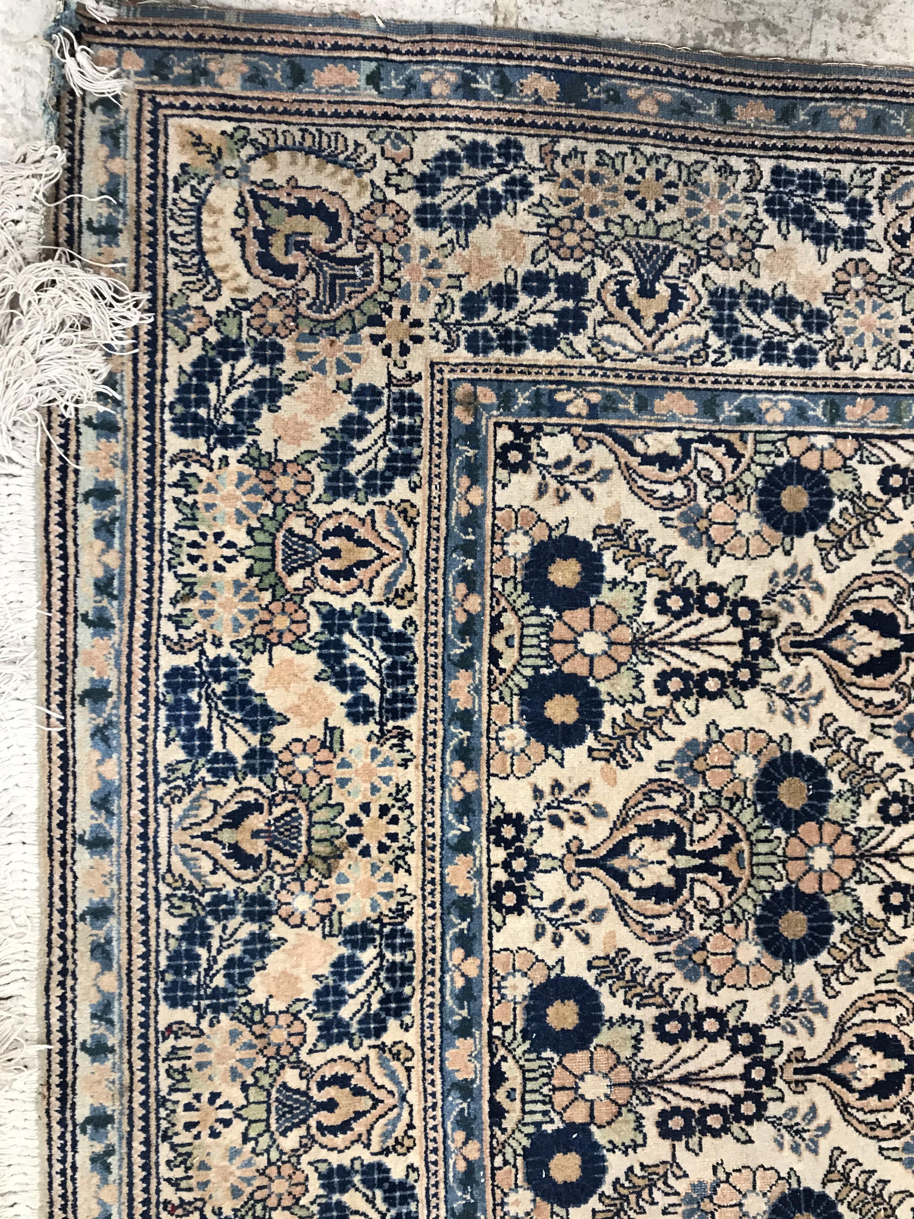 A pair of Persian rugs, the central panel set with repeating floral motifs on a cream ground, - Image 9 of 18