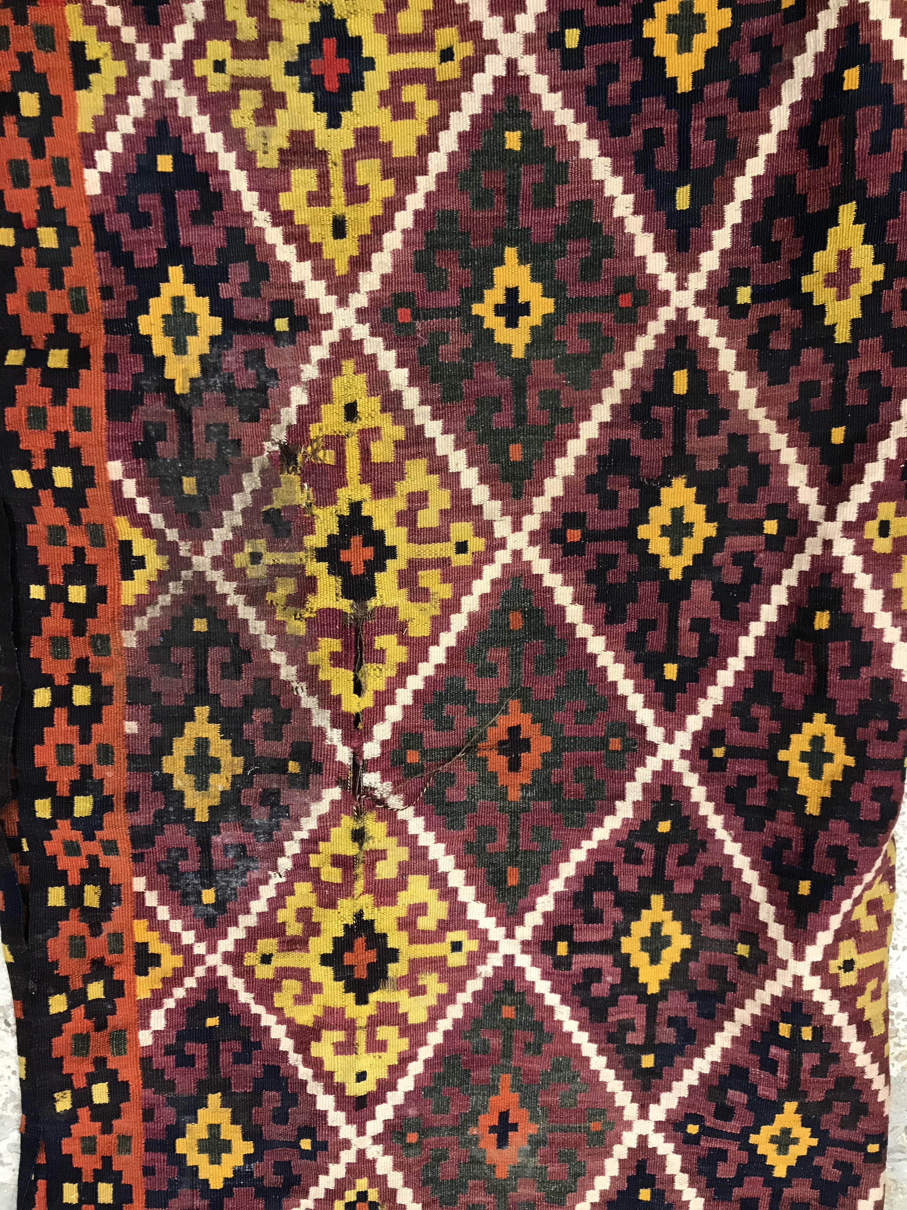 A Kelim rug, the central panel set with all-over lozenge decoration on a purple and orange ground, - Image 7 of 12