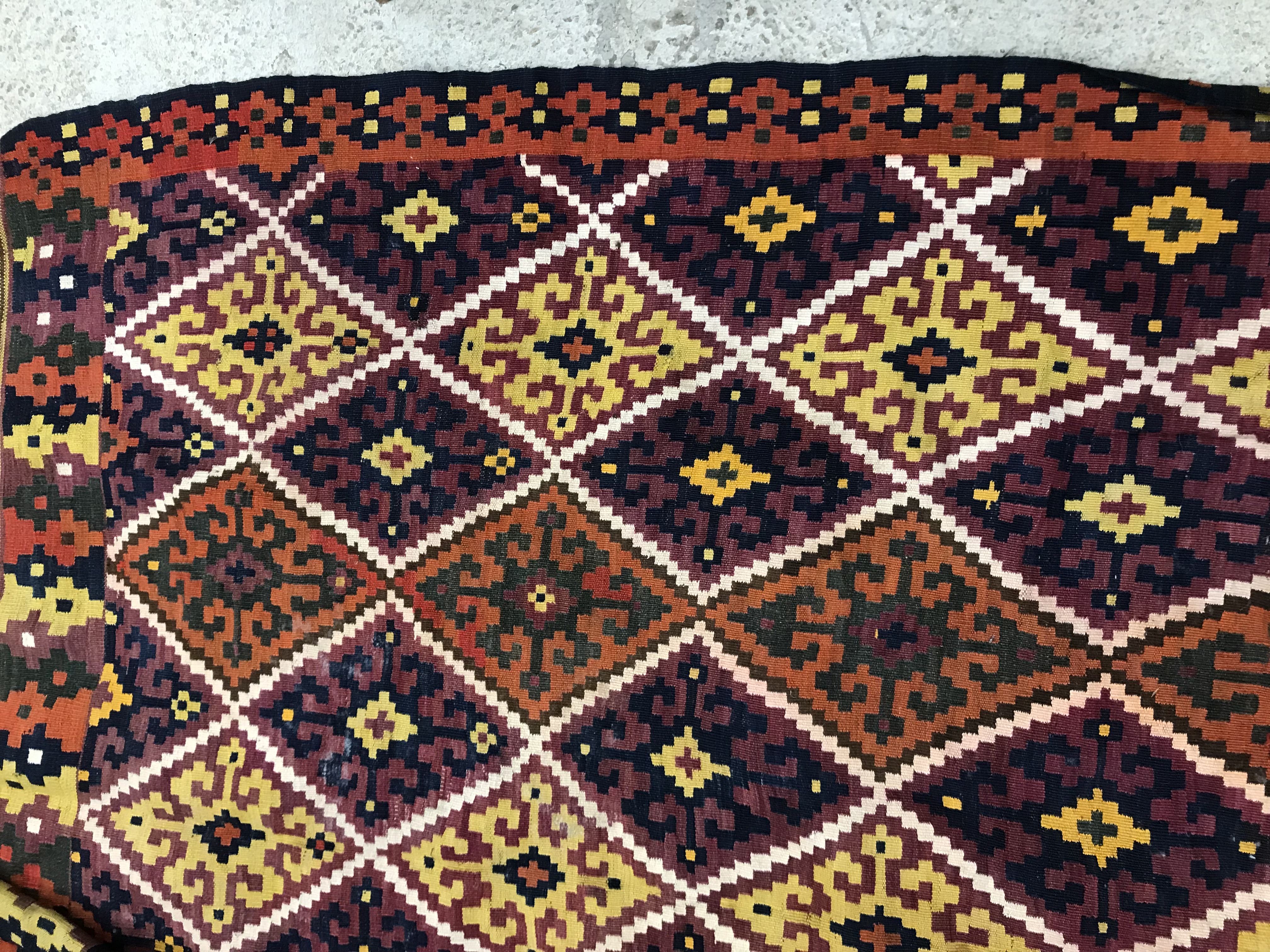 A Kelim rug, the central panel set with all-over lozenge decoration on a purple and orange ground, - Image 4 of 12