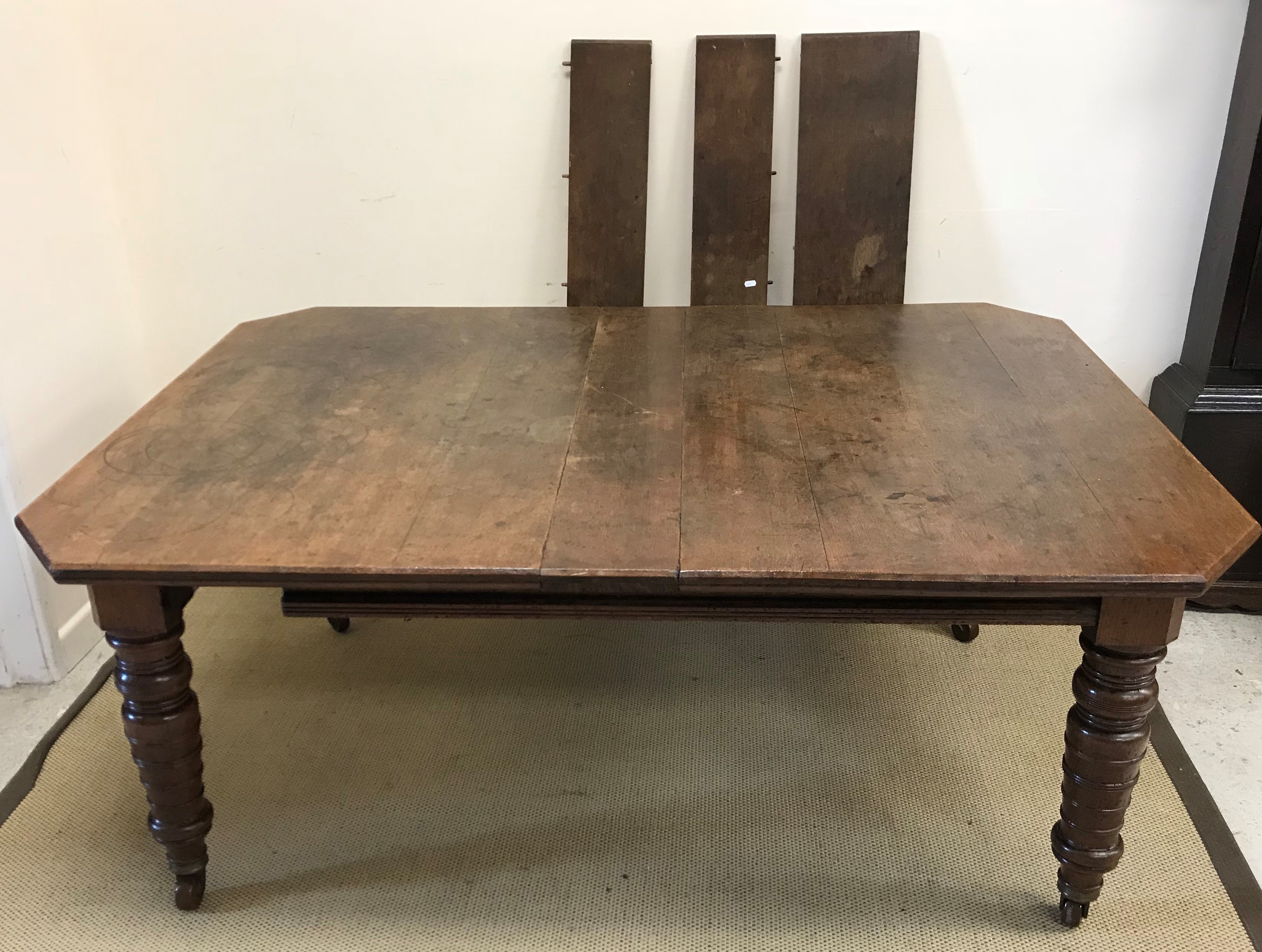 A Victorian oak extending dining table,