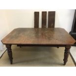 A Victorian oak extending dining table,