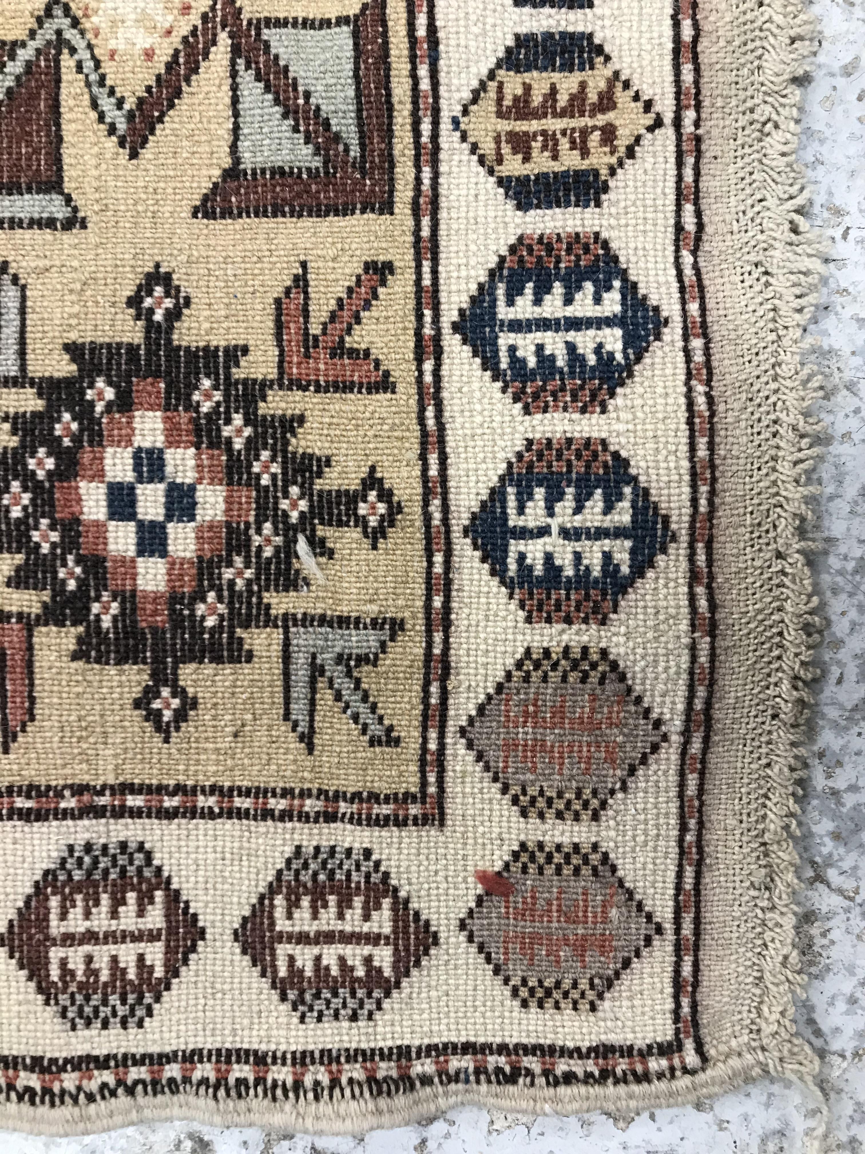 A Caucasian rug, the central panel set with five repeating medallions on a salmon pink ground, - Image 2 of 13