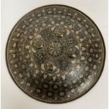A 19th Century Indian white metal embellished brass punch shield with all over floral and foliate