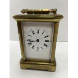 A brass cased carriage clock of small proportions,