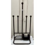 A modern wrought iron two pair boot rack with central handle 40 cm wide x 87 cm high