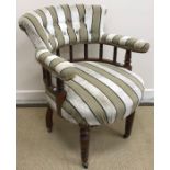 A Victorian oak framed button back elbow chair with galleried back rail and shaped seat on turned