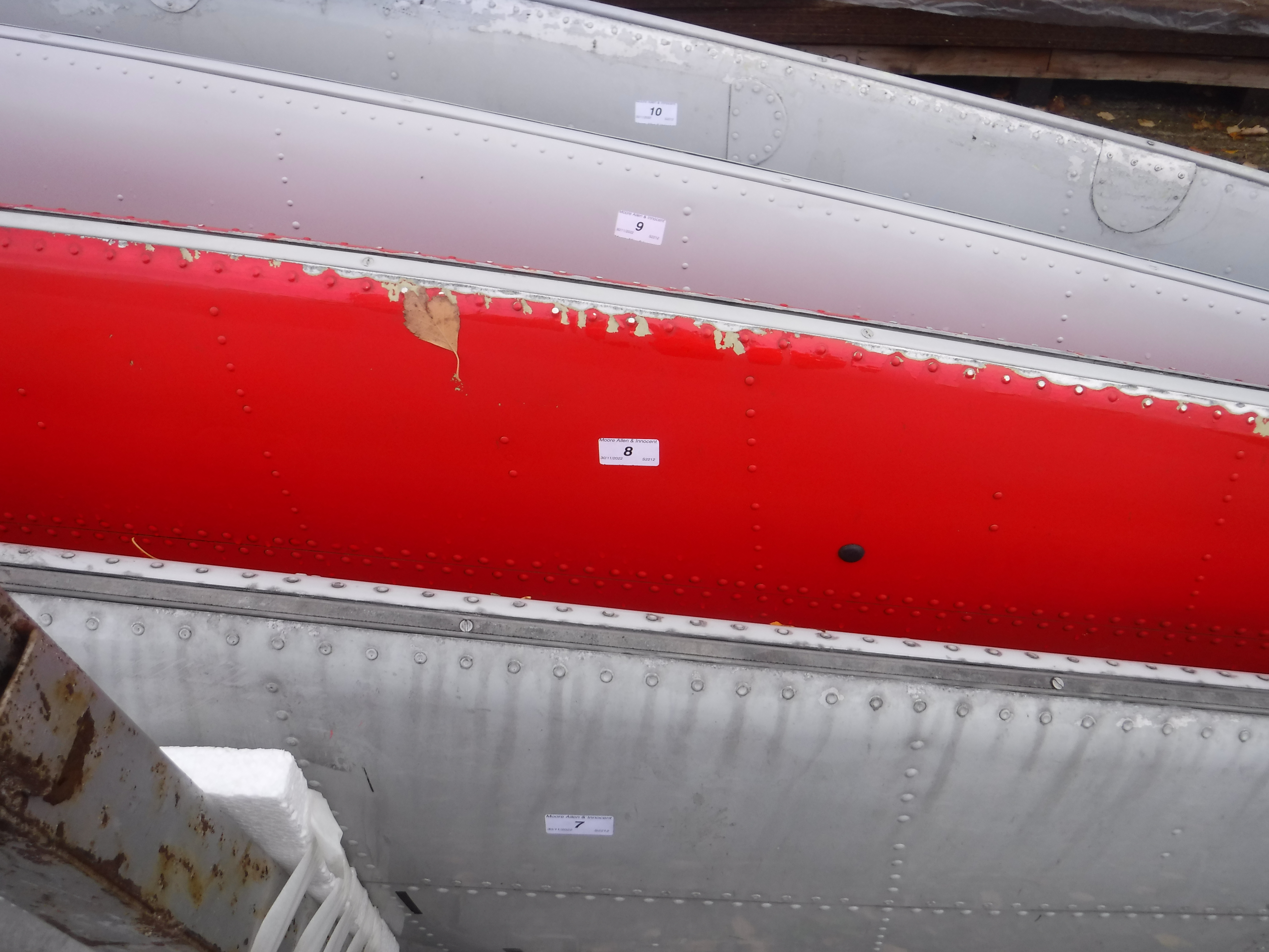 A red painted aircraft tail fin section inscribed "DTD-5580 Titanine",