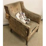 A circa 1900 floral upholstered swept arm chair on square tapered legs to brass caps and later