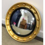 A Regency style giltwood framed circular wall mirror,