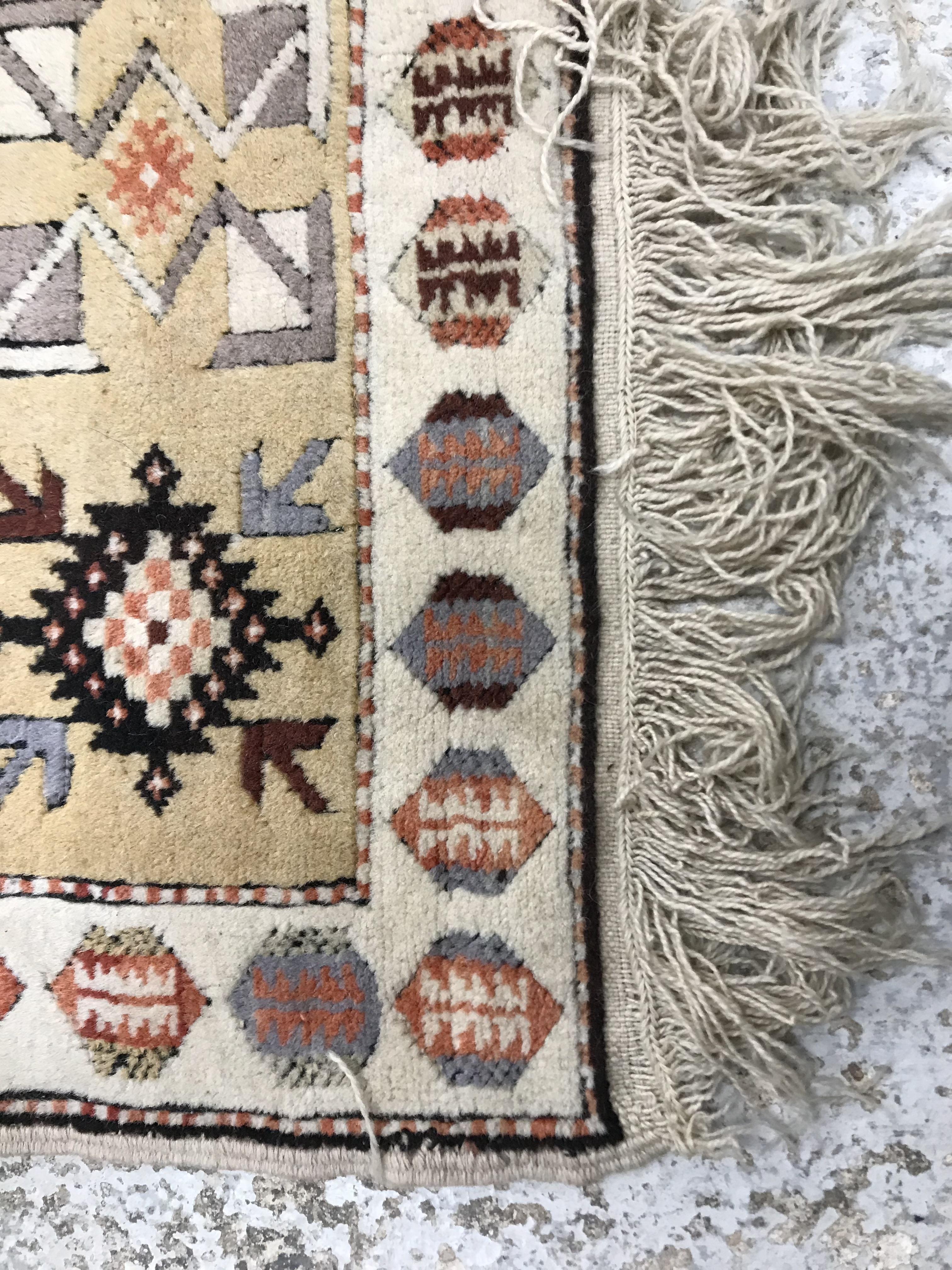 A Caucasian rug, the central panel set with five repeating medallions on a salmon pink ground, - Image 4 of 13