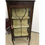 An Edwardian mahogany and inlaid display cabinet with single glazed door enclosing two shelves