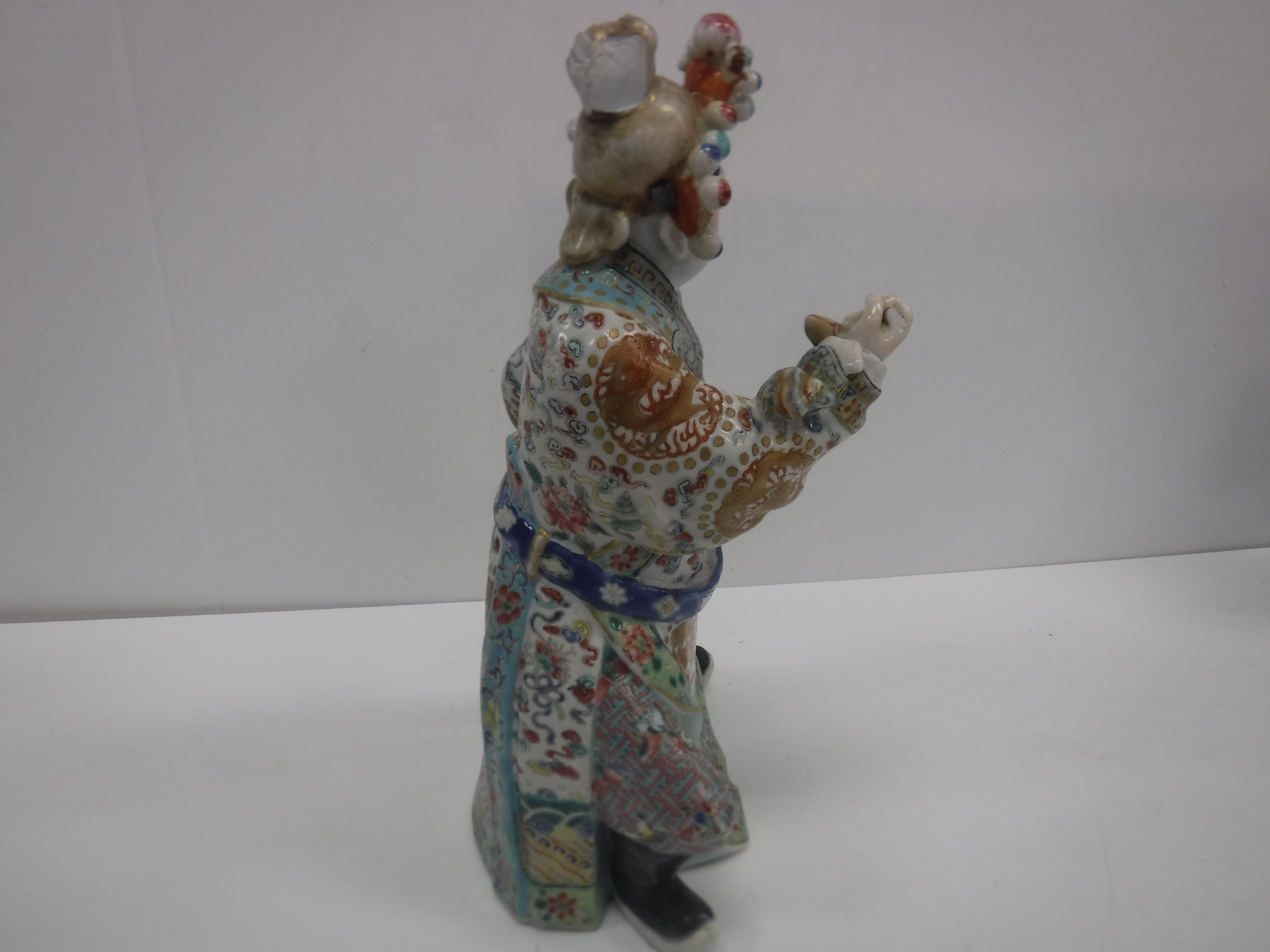 A set of three 19th Century Chinese polychrome decorated figures, one seated, one bearing sword, - Image 18 of 37