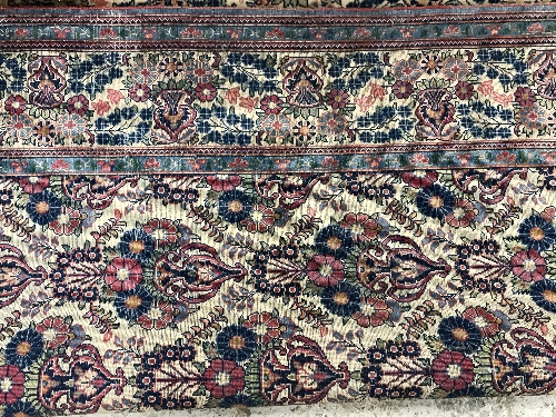 A pair of Persian rugs, the central panel set with repeating floral motifs on a cream ground, - Image 14 of 18