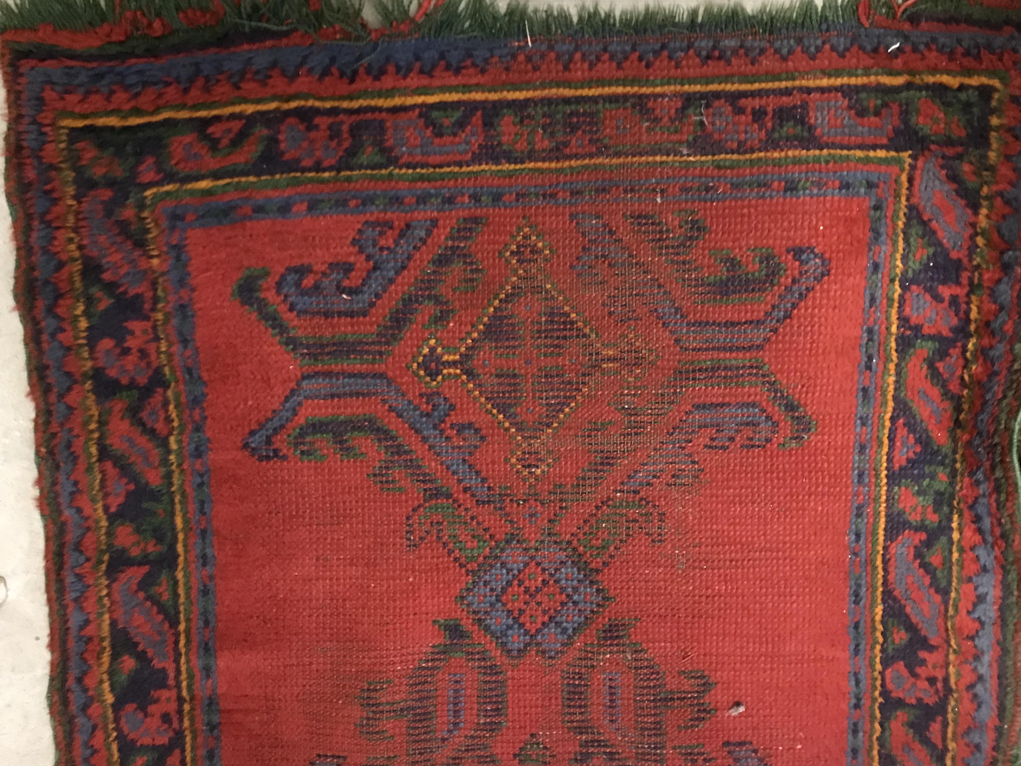 A Donegal rug, the central panel set with stylised cross medallion on a red ground, - Image 22 of 26