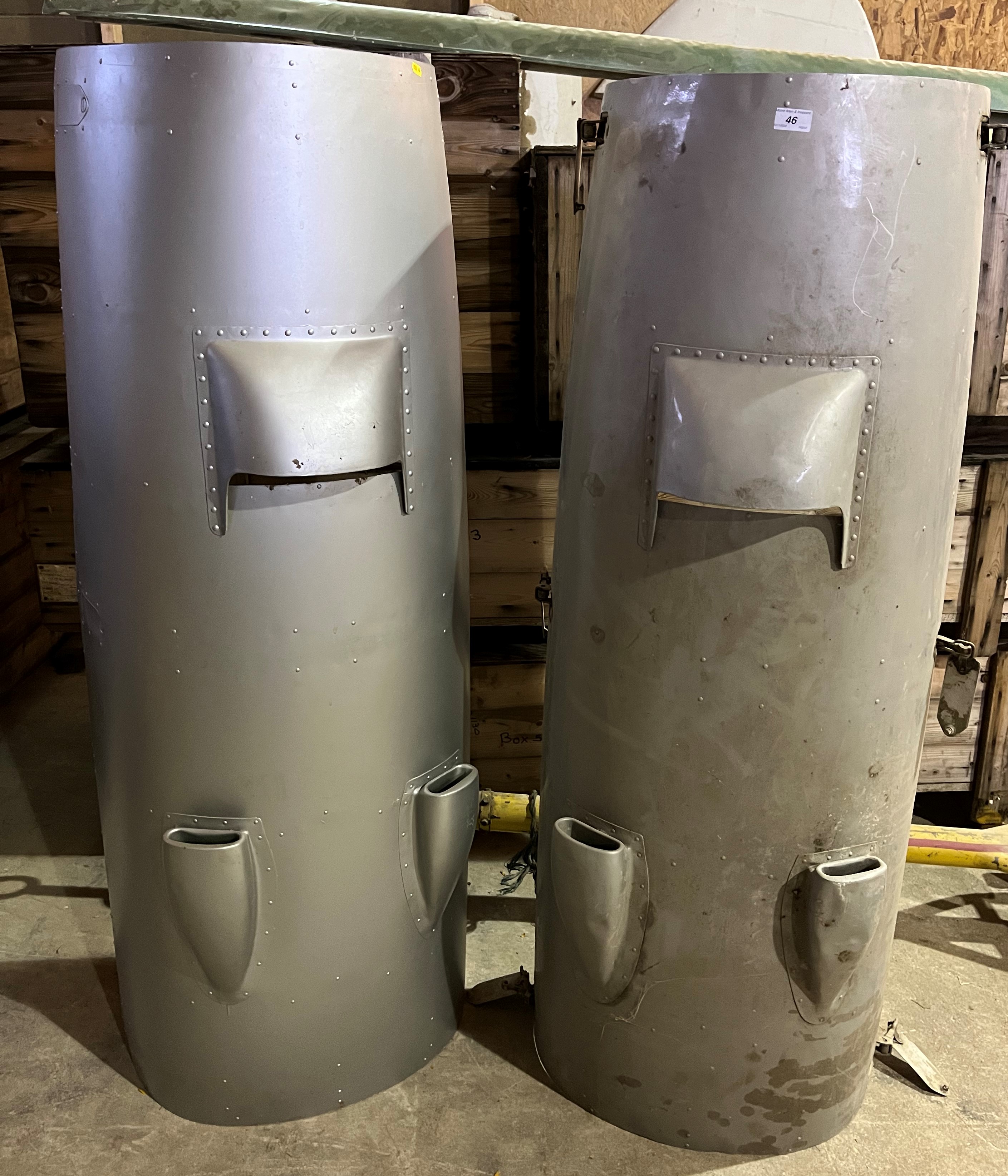 Two painted aluminium engine covers, believed to be De Havilland Devons,